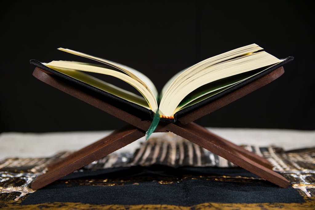 A Quran displayed open on a traditional wooden stand, highlighting its significance.