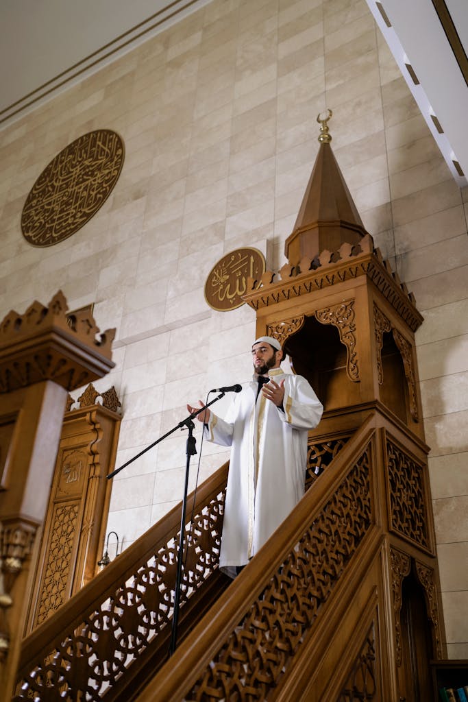 Imam delivering a sermon inside a mosque, emphasizing faith and guidance.
